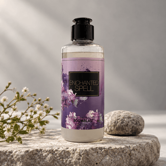 Bottle of 'Enchanted Spell' product on a marble surface with lemons, flowers, and herbs.