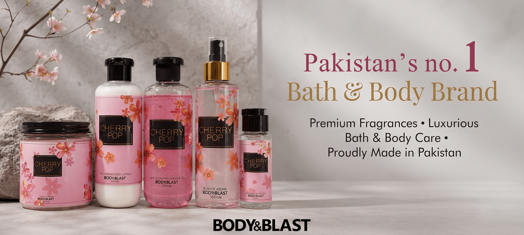 BODY&BLAST, decorated with cherry blossom patterns, displayed against a neutral gray background with text highlighting their status as Pakistan's no. 1 Bath & Body Brand.
